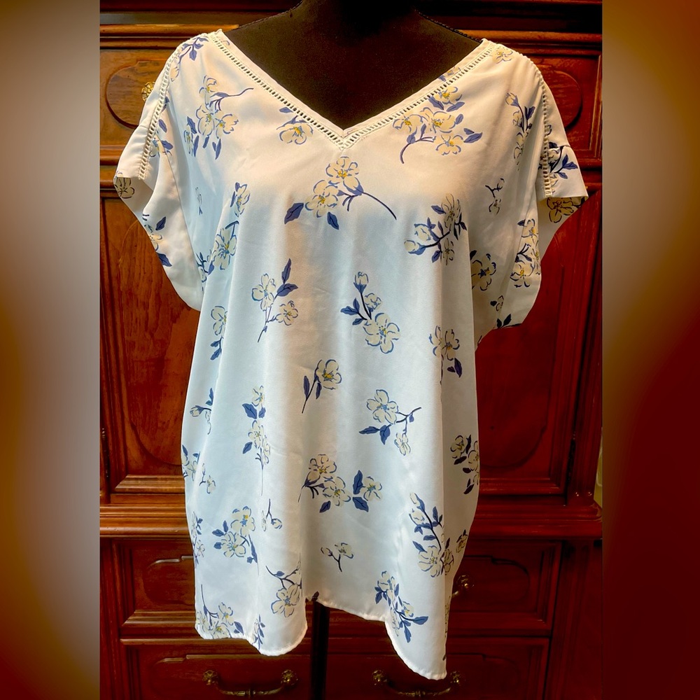 Flowy, lightweight blouse with blue, cream, and yellow flower pattern